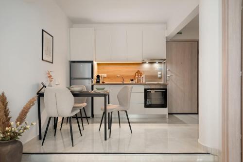a kitchen with a table and chairs in a room at Estia Premium Apartments - Superior Suite Vackhou 1 in Thessaloniki