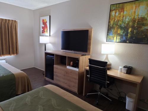 une chambre d'hôtel avec un bureau, une télévision et un lit dans l'établissement Edn Hotel Lincoln, à Lincoln