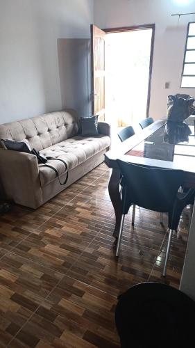 a living room with a couch and a table at Casa MARAIMAU in Encarnación