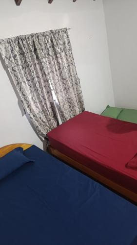 a bed with a curtain on top of it at Casa MARAIMAU in Encarnación