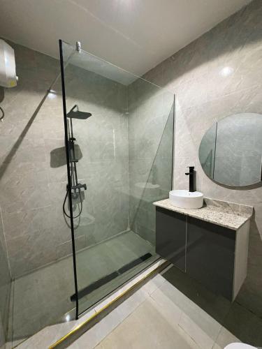 a bathroom with a shower and a sink at Delmori Homes in Enugu