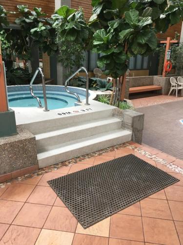 a swimming pool with stairs next to a sidx sidx sidx at Travelodge by Wyndham Winnipeg East in Winnipeg