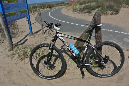 a bike parked on the side of a road at Bed&Breakfast aan Strand in Katwijk aan Zee