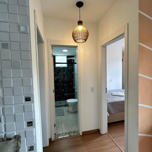 a bathroom with a toilet and a bedroom at Grace Prime Loft – Comfort in Extrema, MG in Extrema