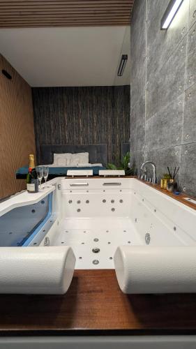 a bathroom with a large tub with white towels at Szampan i Truskawka in Toruń