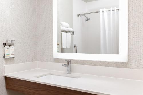a bathroom with a white sink and a mirror at Holiday Inn Express & Suites Las Vegas SW Springvalley by IHG in Las Vegas