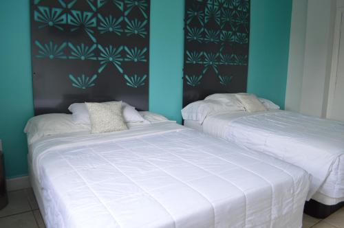 two beds sitting next to each other in a bedroom at Miami Sun Hotel - Downtown/Port of Miami in Miami