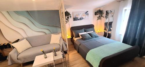 a bedroom with a bed and a couch and a mirror at Holiday Home Ulika in Fažana