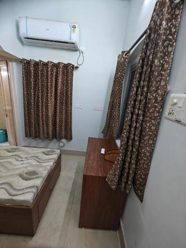 Habitación con cama, cortinas y ventana en Comic hotel, en Raipur