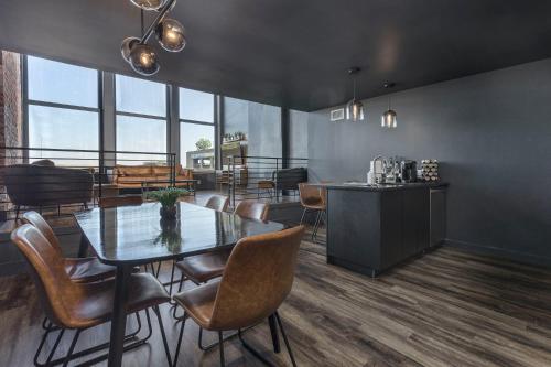 a dining room with a table and chairs at DerbyCity Plush Loft Gather in Style by Hollyhock in Louisville