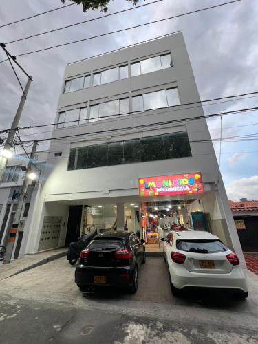 two cars parked in front of a building at Portobelho in Cúcuta