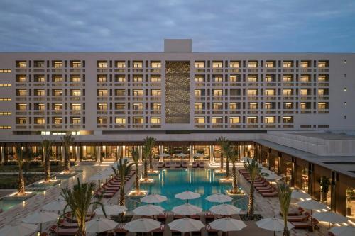 an exterior view of a hotel with a swimming pool at The Landmark Nicosia, Autograph Collection in Nicosia
