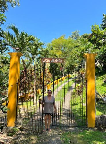 una donna in piedi davanti al cancello di un parco di Casa Alemán a Flores