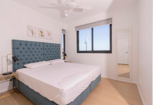 a bedroom with a large bed and a window at Boutique Apartments Southport in Gold Coast