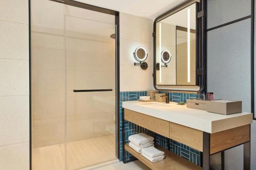 a bathroom with a sink and a mirror at Four Points by Sheraton Anshun, Huangguoshu in Anshun