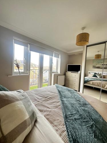 a bedroom with a large bed and a window at Castle View, Cosy Stay in Strood