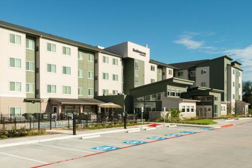 a rendering of a building with a parking lot at Residence Inn Pearland in Pearland