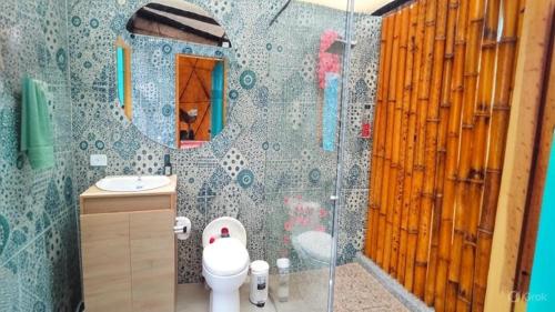 a bathroom with a shower with a toilet and a sink at Prana Hills in Estación El Salto