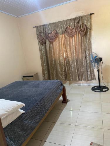 a bedroom with a bed and a window with a fan at Favale in Rivera