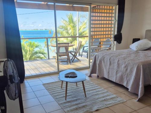 a bedroom with a bed and a view of the ocean at Studio with a view of a heavenly lagoon in Bora Bora