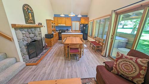 a living room with a table and a kitchen at Circle 4 Condo 14 in Sunriver