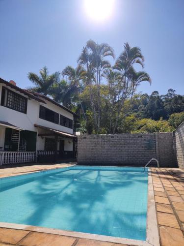 a swimming pool in front of a house at Espaço 579 in Miguel Pereira