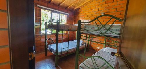 Ένα ή περισσότερα κρεβάτια σε δωμάτιο στο Finca Piscina Playita Kiosco Bar Combia - Estación Pereira