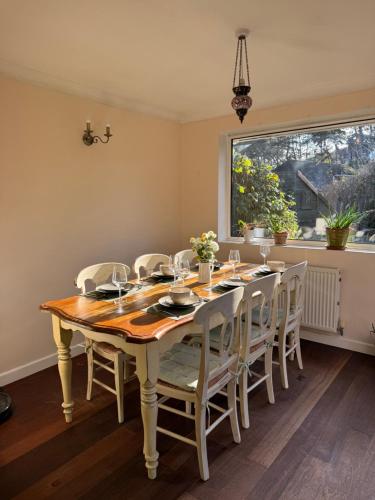 a dining room with a table and chairs and a window at Beach Bungalow in Bournemouth