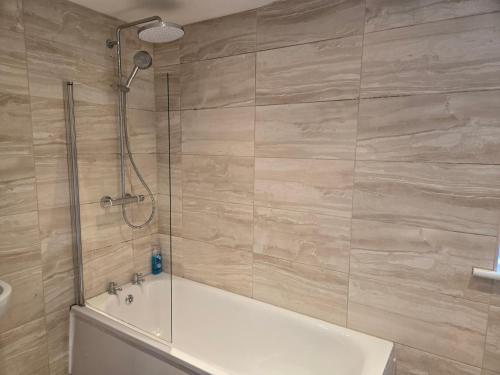 a bathroom with a shower and a bath tub at Lantern House in Bristol