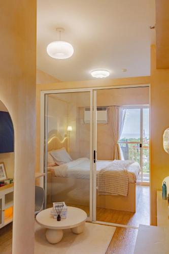 a bedroom with a bed and a table in a room at Meraki Urban in Davao City