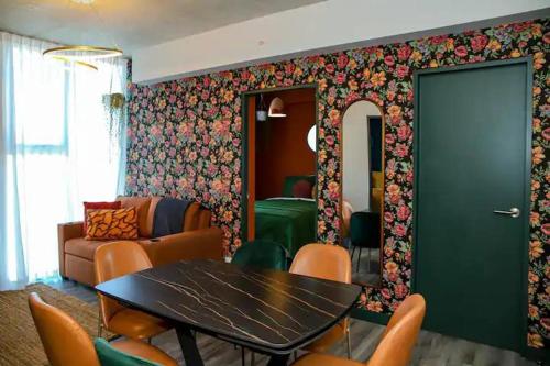 a dining room with a table and a couch at Bloum at 22, City Views and Wonderland Vibes! in Hatillo