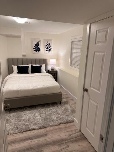 a bedroom with a bed and a window and a door at Cozy Home Away from Home in Kingston