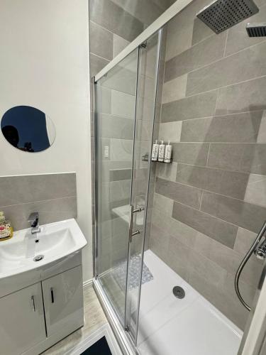 a bathroom with a shower and a sink at 216 High Street Abroath Apartment 1 in Arbroath