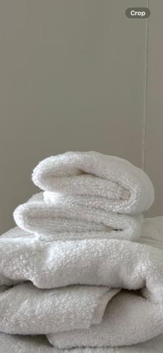 a pile of white towels stacked on top of each other at The Perfect Place in Ennis
