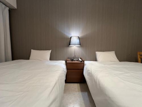 Postel nebo postele na pokoji v ubytování マルチステイ大阪天満