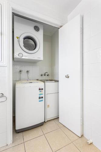 a kitchen with a refrigerator and a microwave at 'Villa Mar Colina U12' Coastal Escape, Yeppoon in Yeppoon