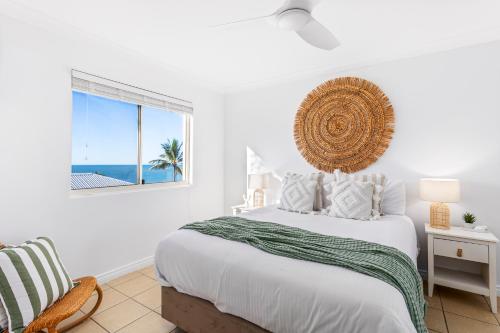 a white bedroom with a bed and a window at 'Villa Mar Colina U12' Coastal Escape, Yeppoon in Yeppoon