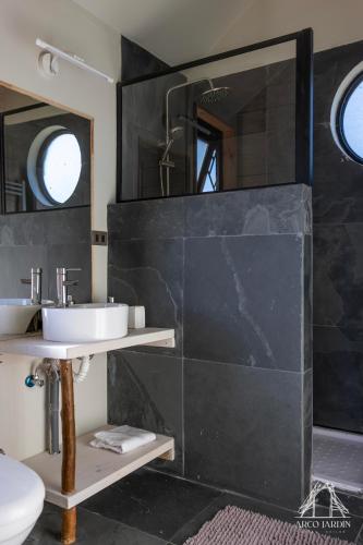 a bathroom with a sink and a mirror at Casas Arco Jardin in Castro