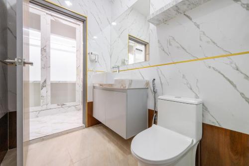 a white bathroom with a toilet and a shower at Sorrento Pool Villa Jomtien Beach in Jomtien Beach