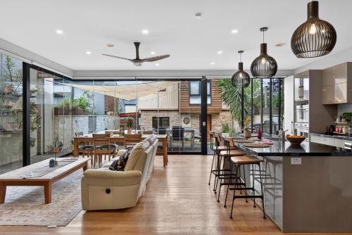a kitchen and living room with a couch and a table at Modern Homestay near Sydney CBD, Leichhardt - Little Italy in Sydney