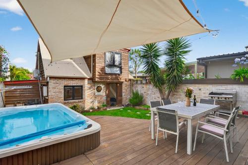 a patio with a table and a swimming pool at Modern Homestay near Sydney CBD, Leichhardt - Little Italy in Sydney