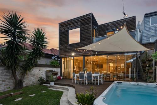 a villa with a swimming pool and a house at Modern Homestay near Sydney CBD, Leichhardt - Little Italy in Sydney