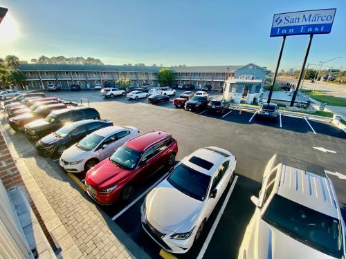 a parking lot with a bunch of cars parked at San Marco Inn East - Jacksonville in Jacksonville