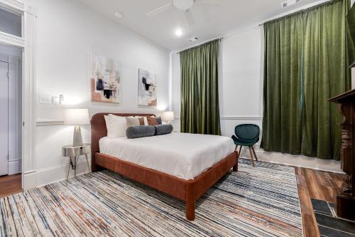 a bedroom with a bed and a green curtain at Nesting Escapes at Abercorn in Savannah