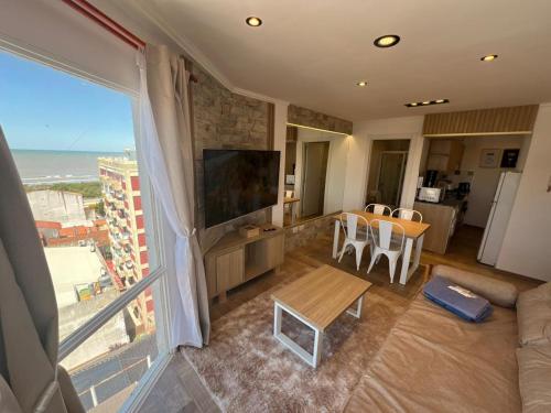a living room with a large window with a view of the ocean at Chiara's Apartament panoramico in Santa Teresita