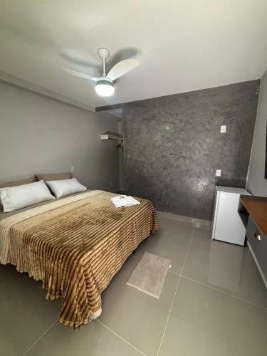 a bedroom with a bed and a ceiling fan at Cantinho da Ilha Suites in Abraão