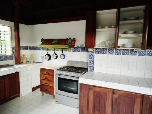 a kitchen with blue and white tiles on the wall at Casa Nalu in San Juan del Sur
