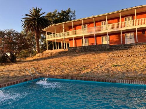 a large house with a swimming pool in front of it at Casona Starlight in Melipilla