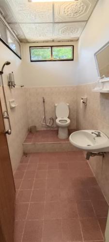 a bathroom with a toilet and a sink at Kohmook cocobeach in Ko Mook