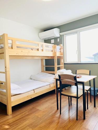 Ένα ή περισσότερα κρεβάτια σε δωμάτιο στο 匠ファームステイ